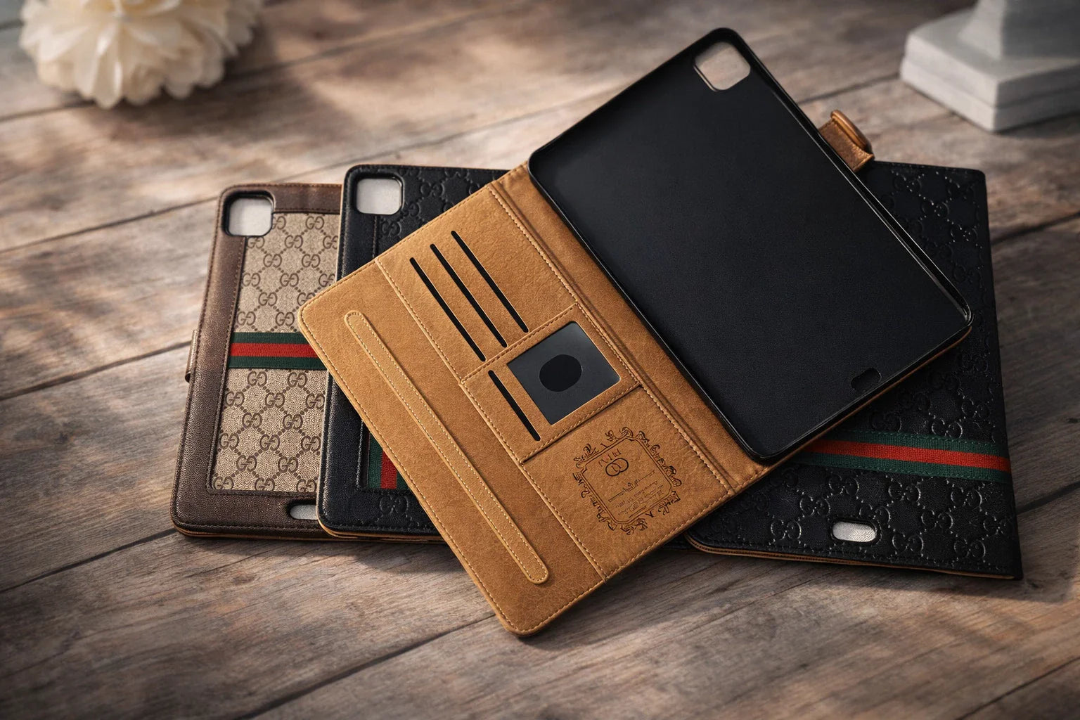 Luxury designer-inspired iPhone wallet cases with cardholder slots and embossed patterns on wood table