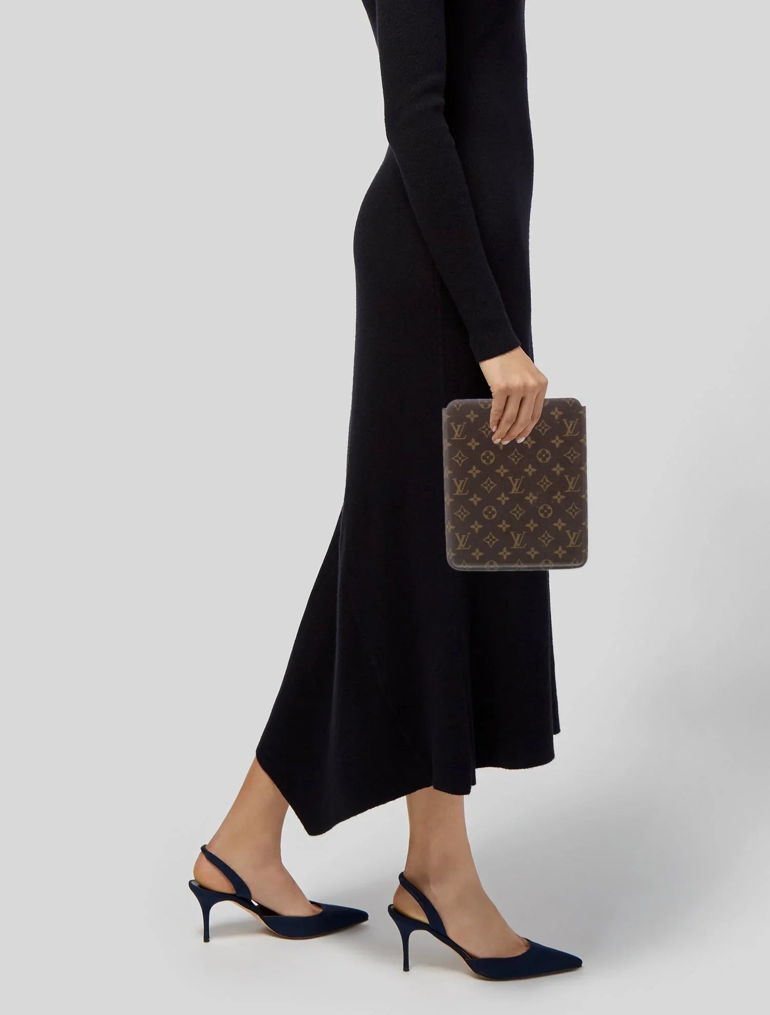 Woman in black dress holding monogram brown designer iPad cover with stiletto heels