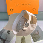 Beige cap on a stand with a Louis Vuitton background