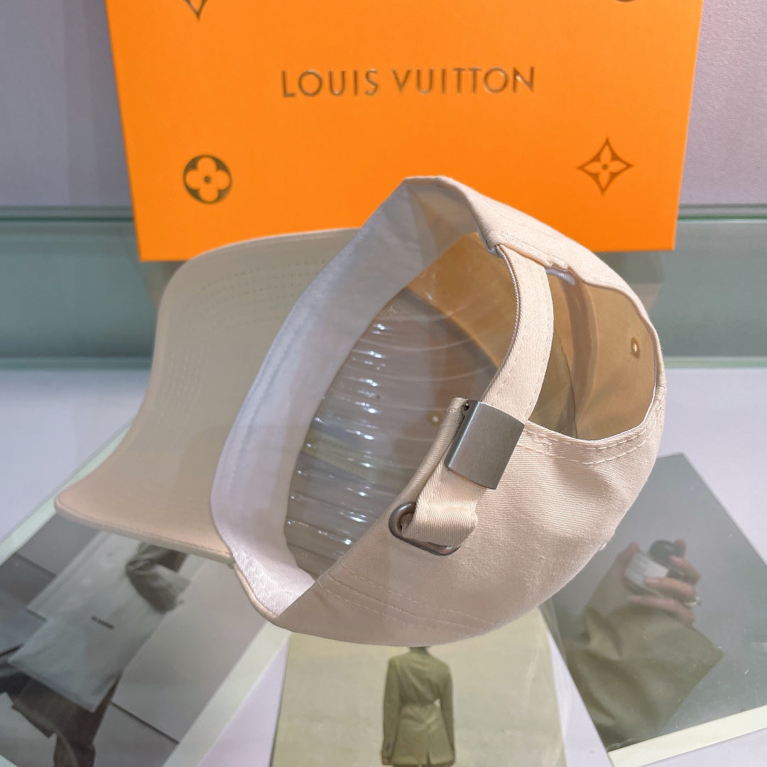 Beige cap on a stand with a Louis Vuitton background