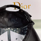 Black cap with Christian Dior logo on a white background