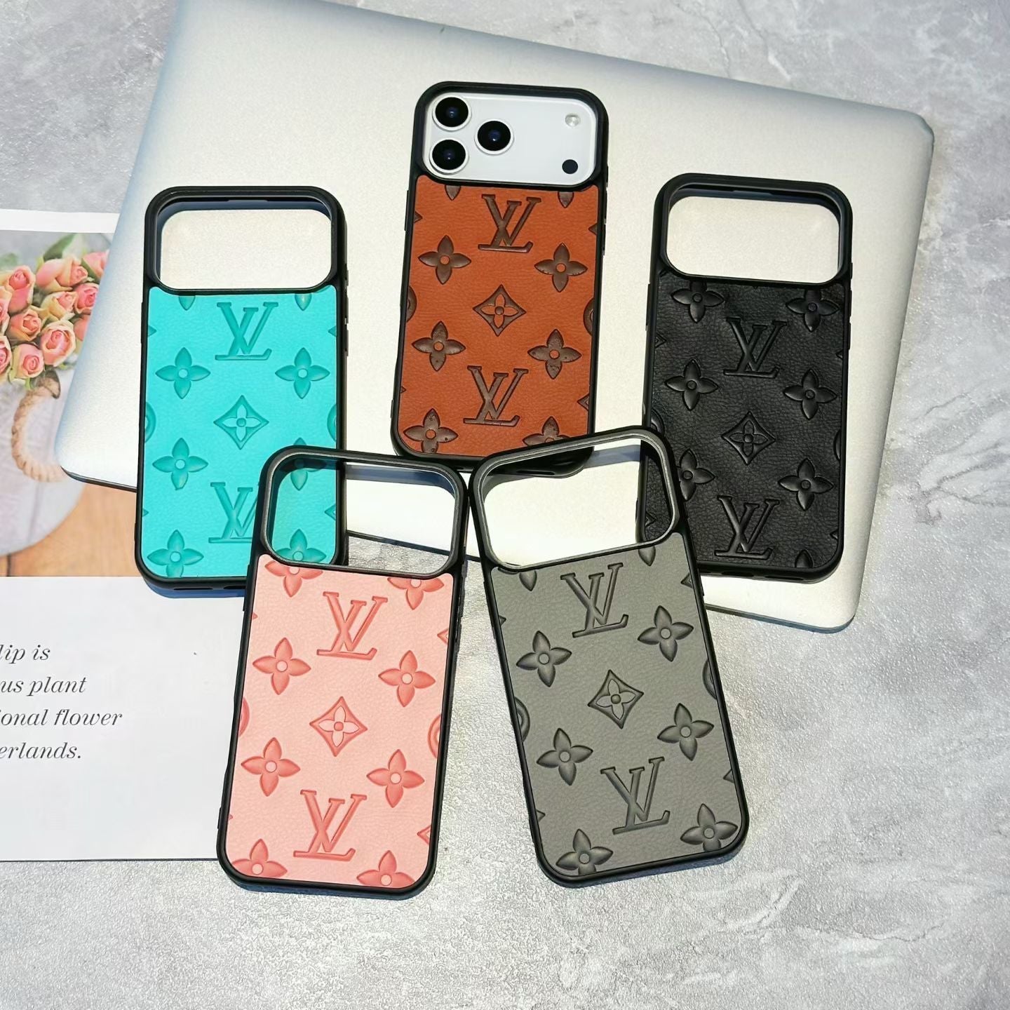 Five phone cases with Louis Vuitton monogram pattern on a gray surface.