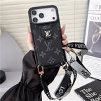 Louis Vuitton phone case with strap held by a hand, with a magazine in the background.