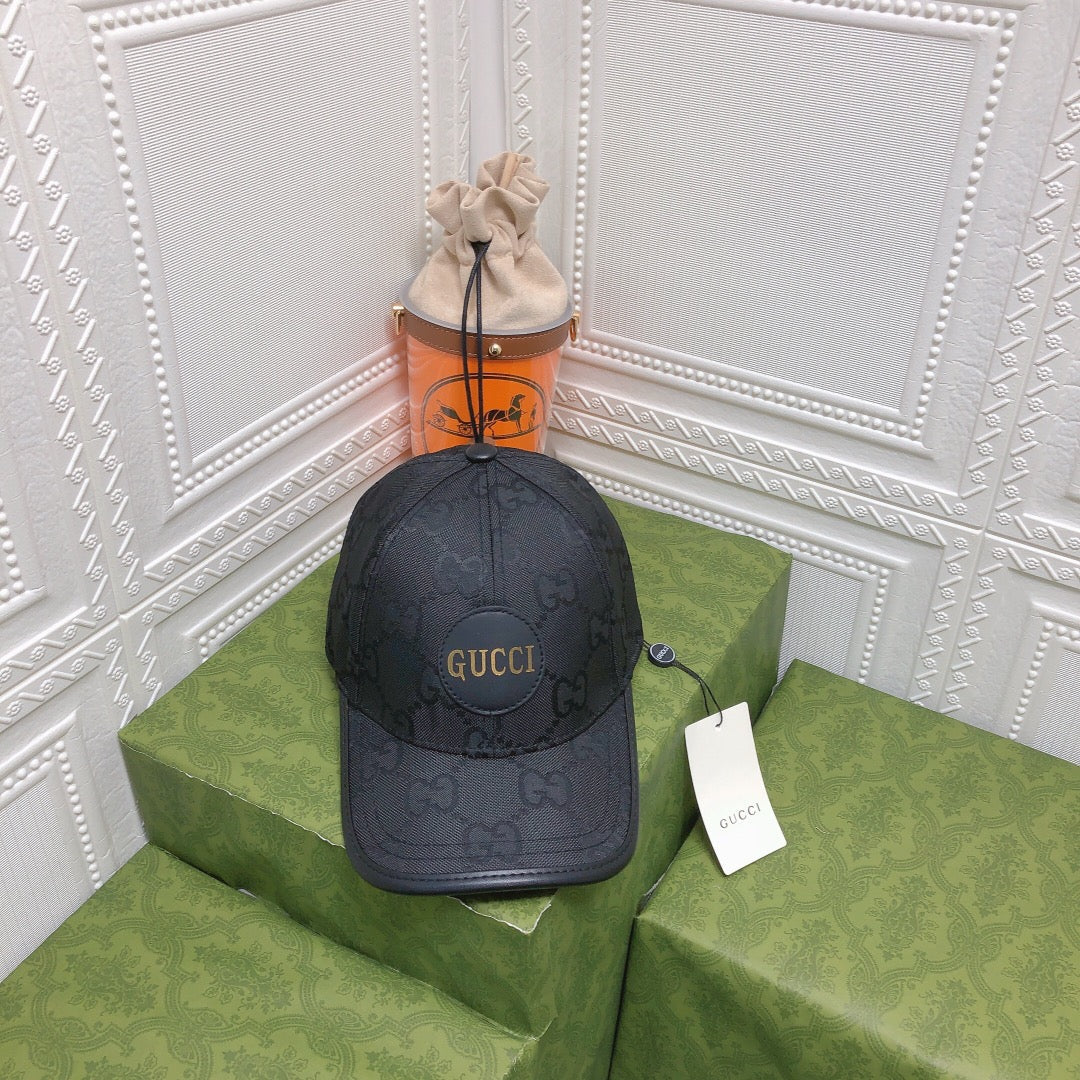 Black Gucci cap on a green box with a white wall background