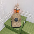 Beige Gucci cap on a green box with a white decorative wall background