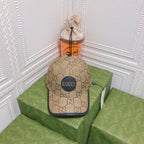 Beige Gucci cap on a green box with a white decorative wall background