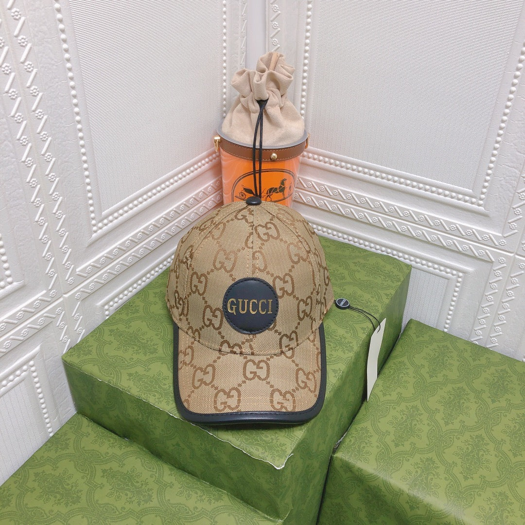 Beige Gucci cap on a green box with a white decorative wall background
