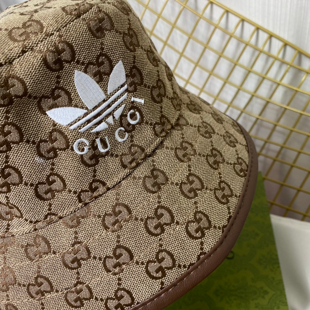 Bucket hat with Gucci and Adidas logos on a white background
