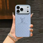 Louis Vuitton phone case held in a hand with a blurred background