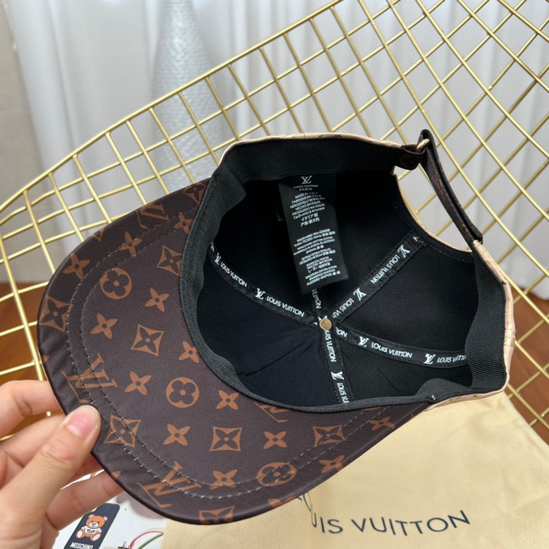Louis Vuitton cap with monogram pattern and brand tag on a gold wire rack.
