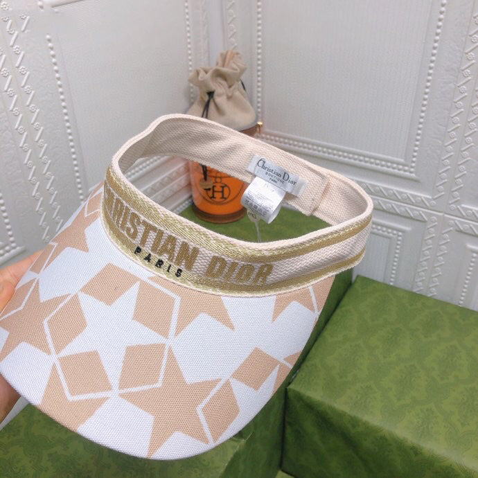 Visor with star pattern and Christian Dior branding on a white background