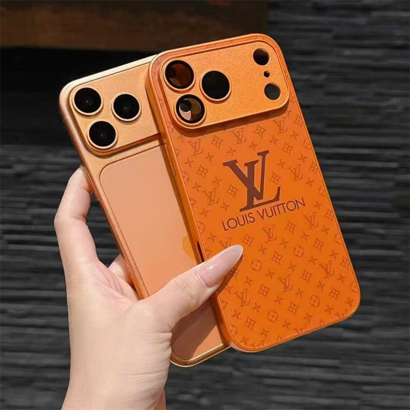 Orange Louis Vuitton phone case held by a hand against a dark textured background