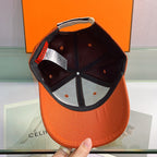 Orange cap with black interior against an orange background