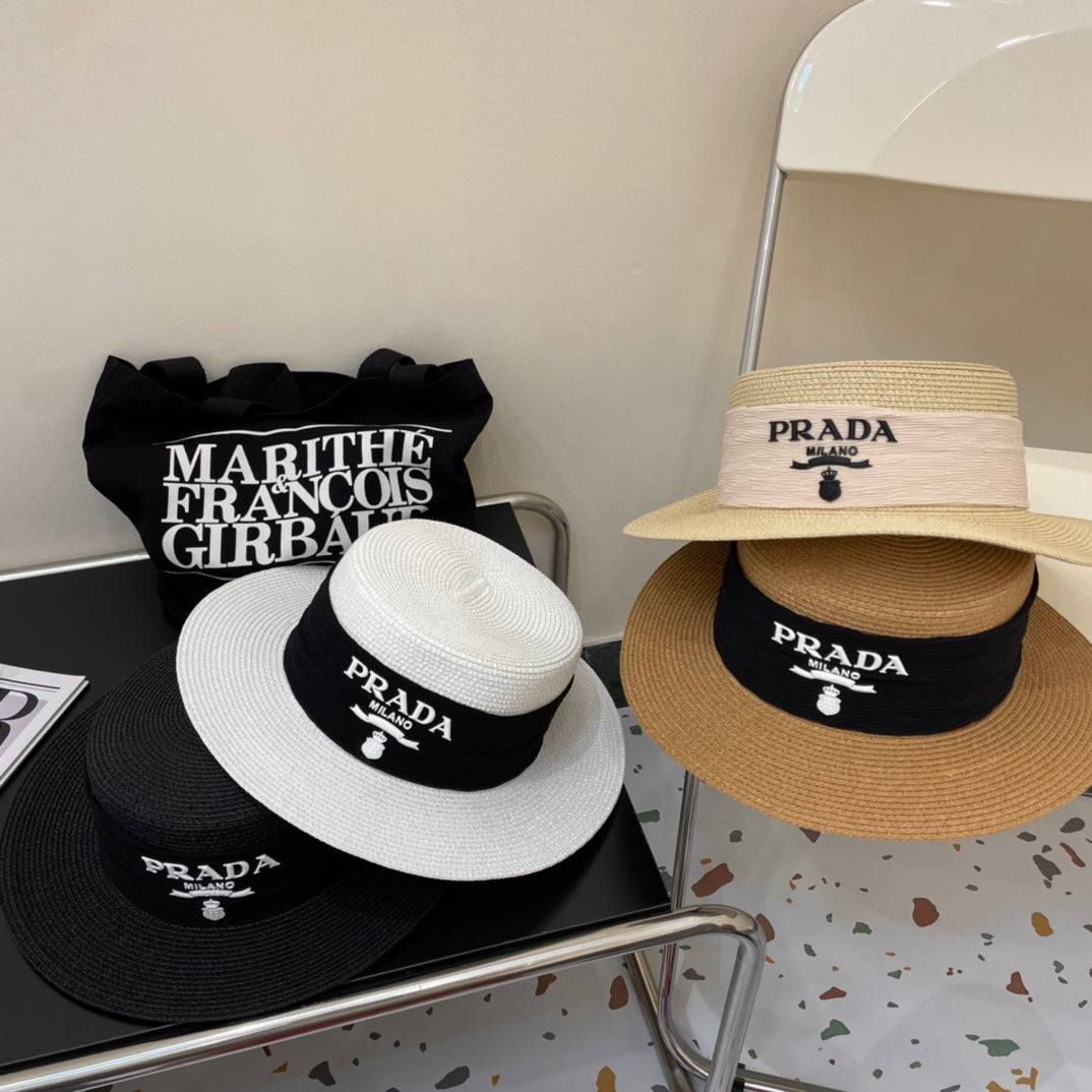 Prada hats displayed on a metal rack with a black bag in the background.