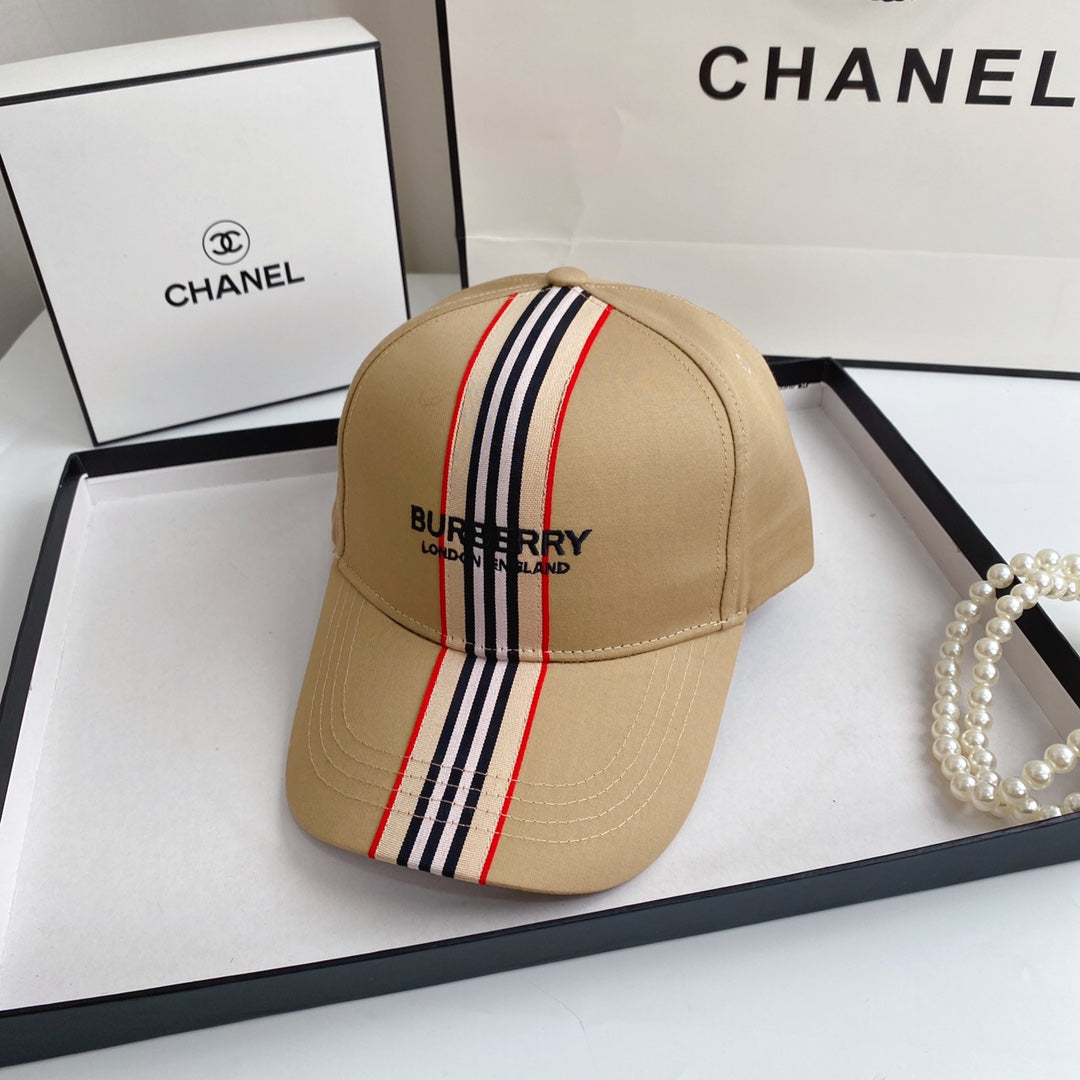 Beige Burberry cap with striped detail on a Chanel branded surface