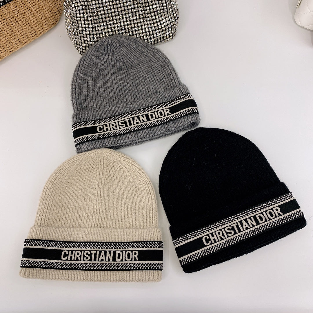 Three beanie hats with Christian Dior branding on a white background
