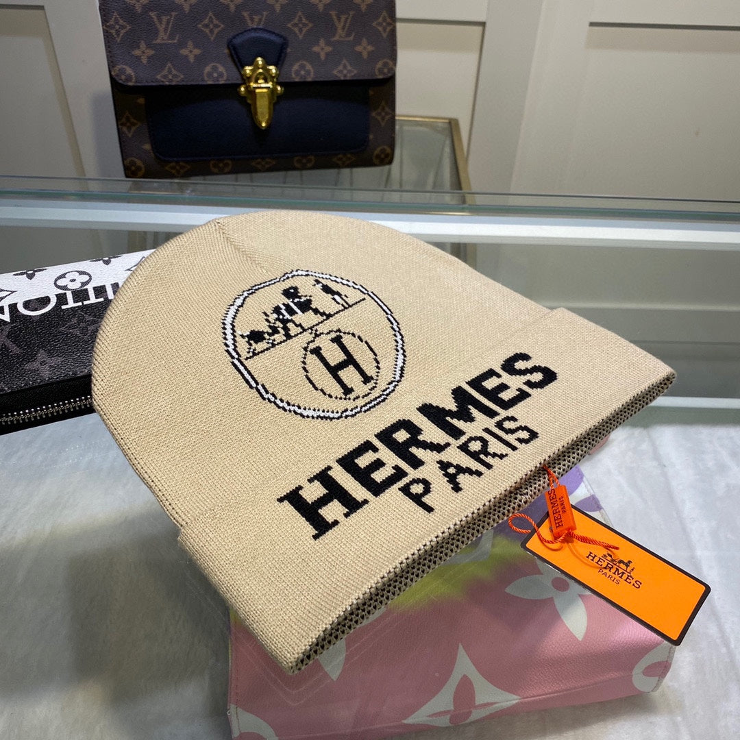 Beige Hermes Paris bag with orange tag on a floral surface