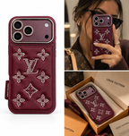 Louis Vuitton monogram phone case in burgundy leather with rhinestone monogram patterns, shown on a phone and in a branded box, with a lifestyle inset of a woman holding the case.