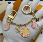 Louis Vuitton flower charm keychain arranged in luxury gift packaging