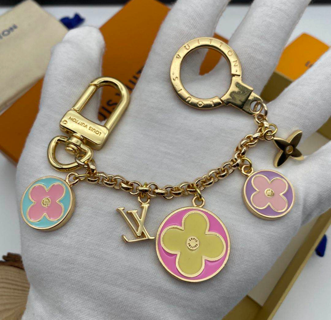 Louis Vuitton flower charm keychain arranged in luxury gift packaging
