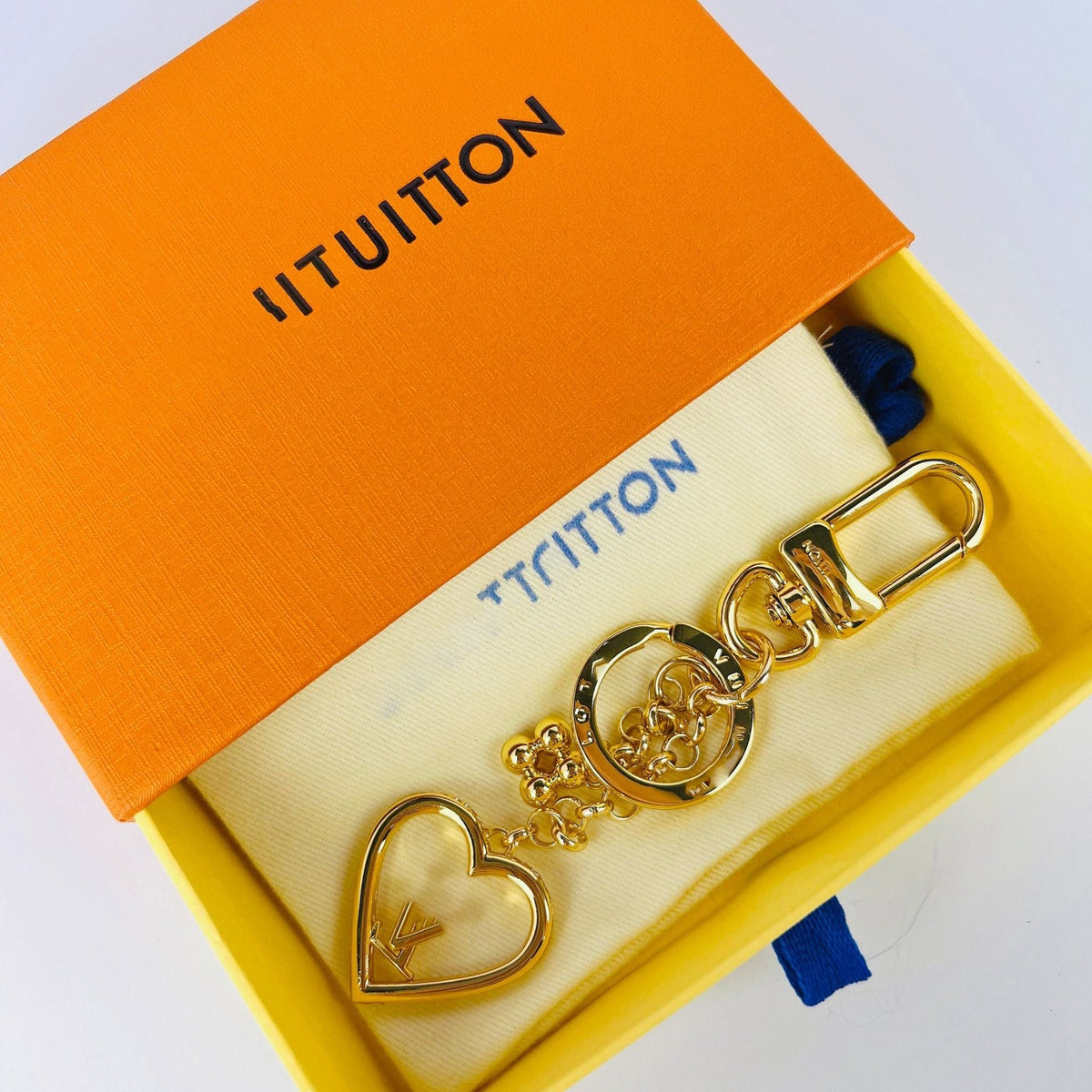 Louis Vuitton heart love charm keychain displayed in orange box