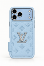 Glacier blue Louis Vuitton-style iPhone 18 Pro Max case with textured monogram pattern and crystal emblem