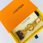 Louis Vuitton monogram mini bag charm keychain displayed in orange box