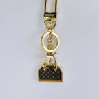 Louis Vuitton monogram mini bag charm keychain with gold-tone clasp
