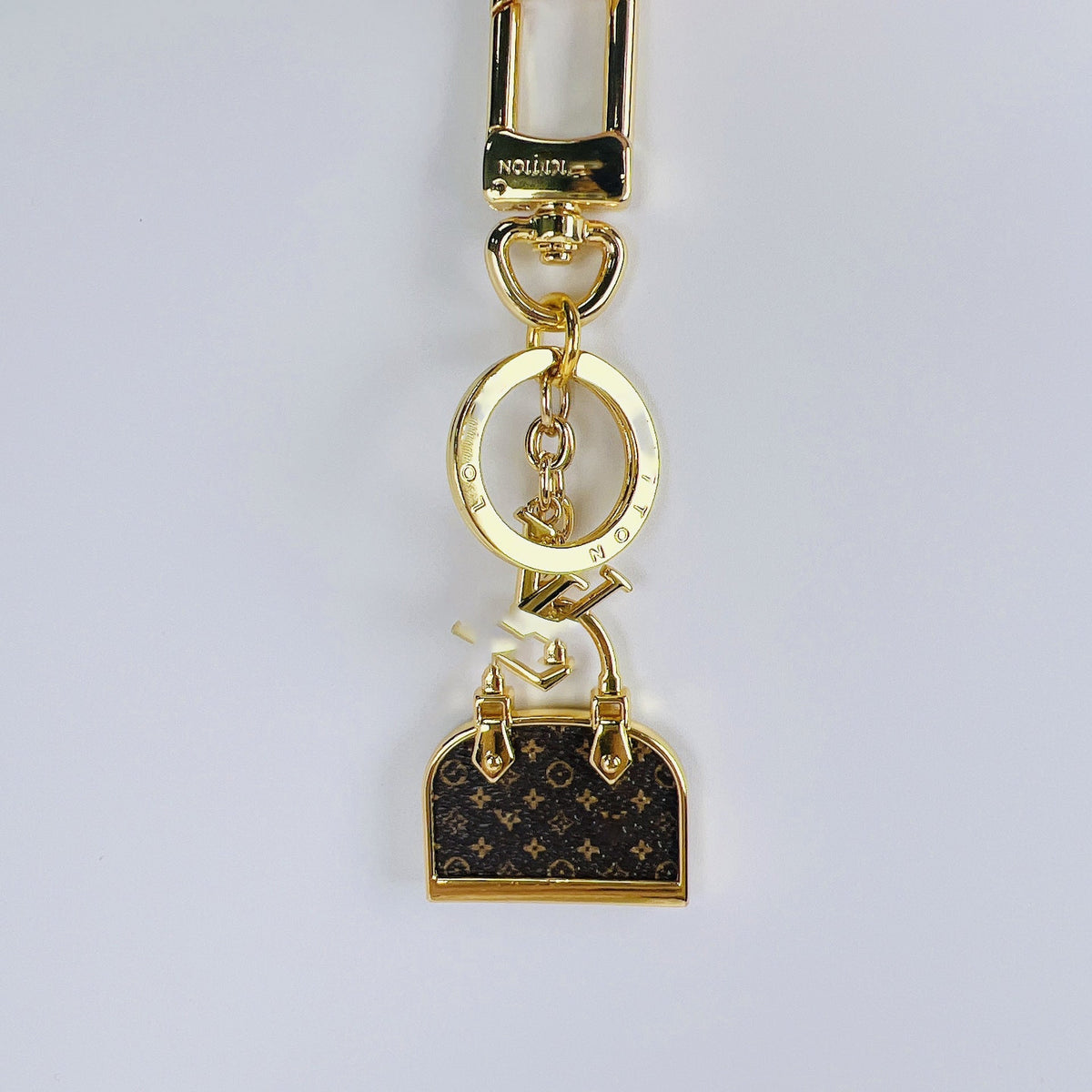 Louis Vuitton monogram mini bag charm keychain with gold-tone clasp