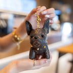 Close-up of Louis Vuitton monogram puppy keychain with gold-tone hardware