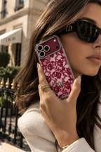 Burgundy Dior-style lace case for iPhone 18 Pro Max with clear frame and gold emblem
