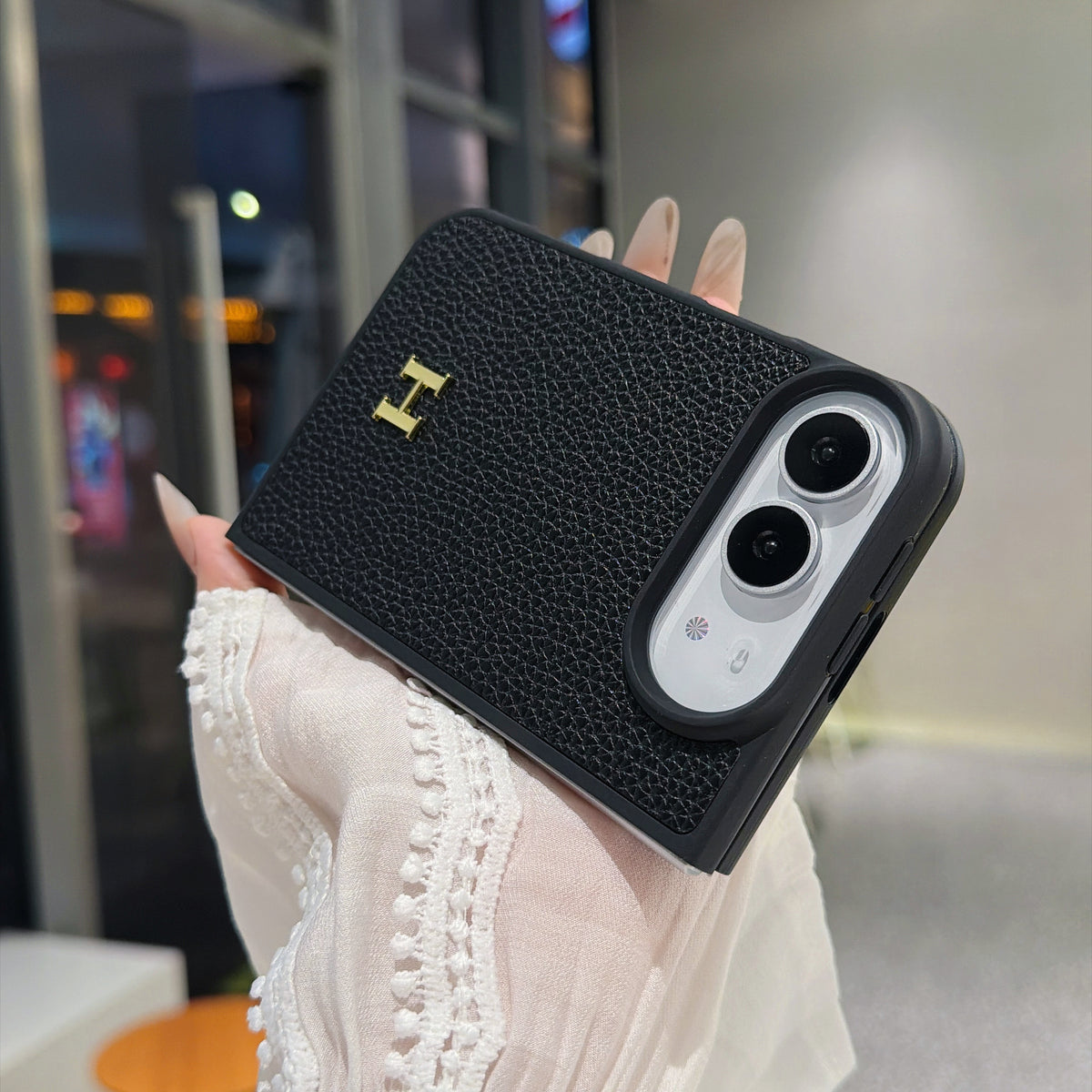Black textured iPhone Duo case with gold-tone H emblem