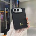 Black pebbled leather-style iPhone Duo case with gold H logo
