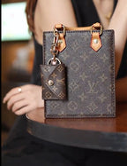 Louis Vuitton monogram mini wallet keychain styled as a bag charm on matching mini tote