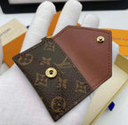 Open Louis Vuitton monogram mini wallet keychain shown on white glove with brown interior
