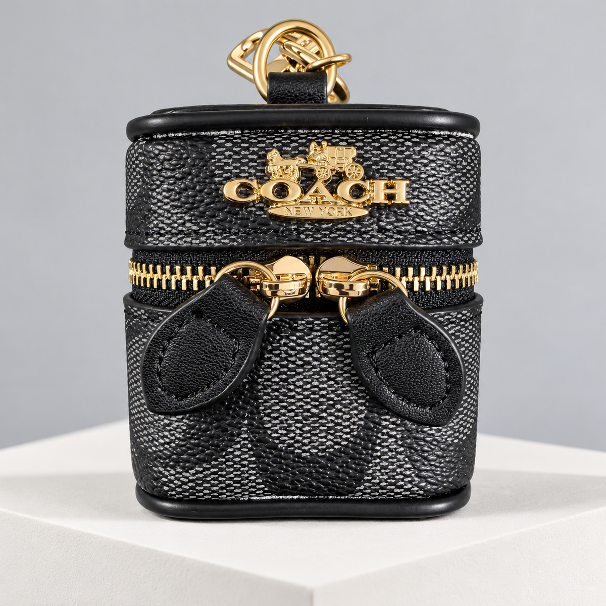 Coach Signature Zip Earbud Pouch in Black — studio view